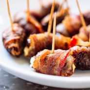 Bacon Wrapped Dates with Goat Cheese on toothpicks.