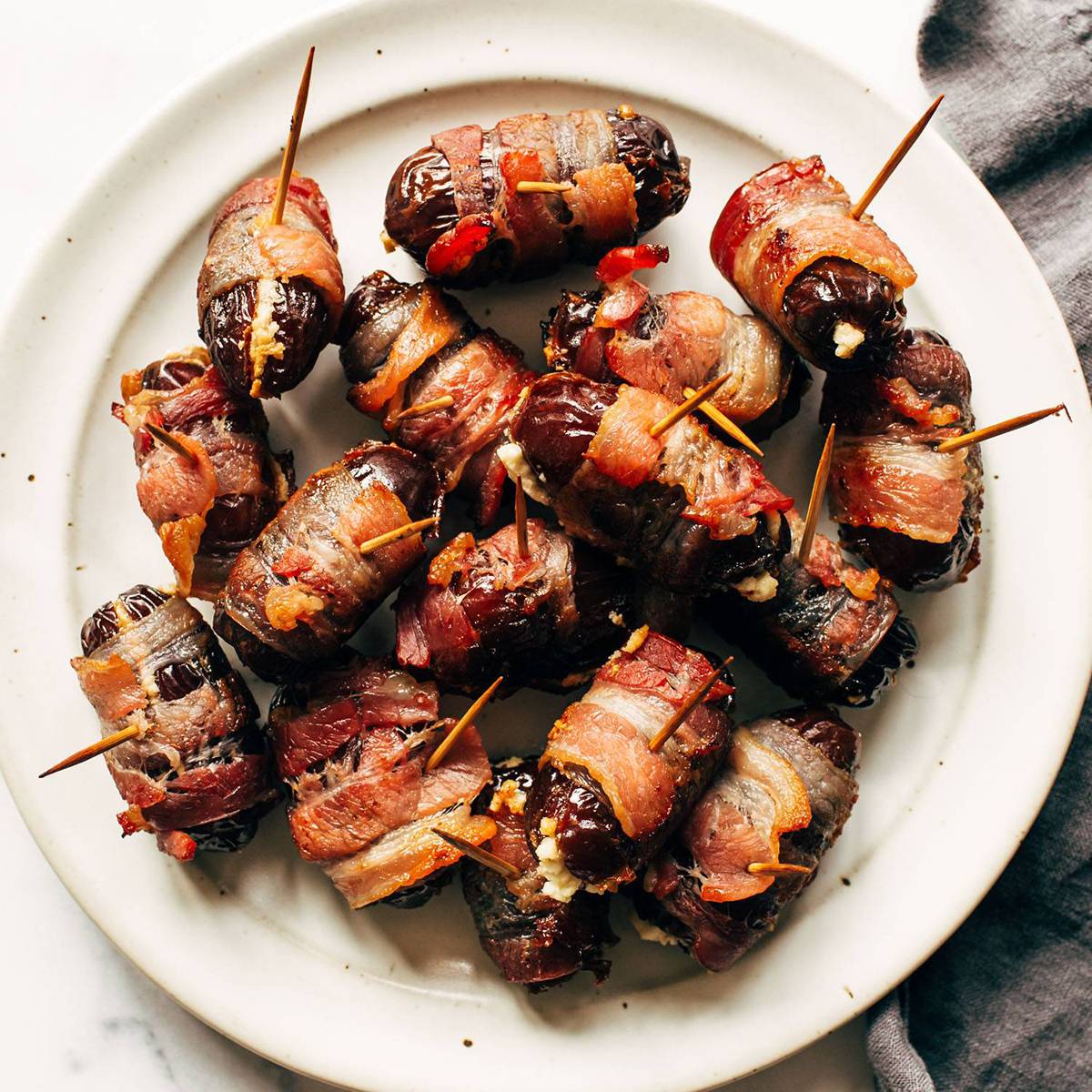 Bacon-wrapped dates on a plate