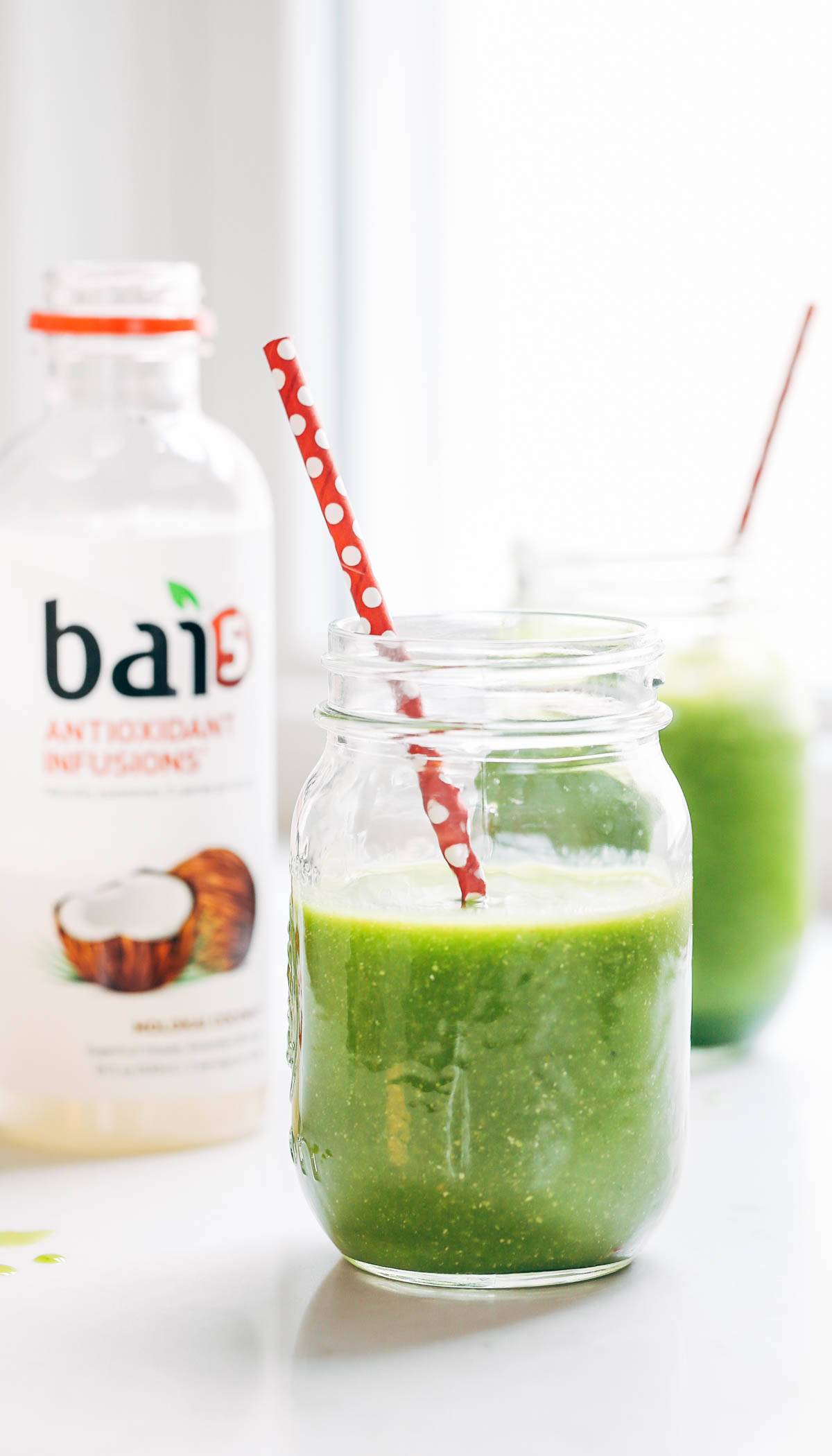 Coconut Green Smoothies in two jars with red straws.