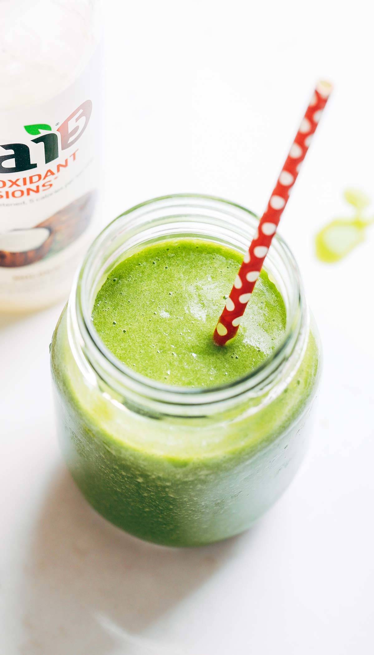 Coconut Green Smoothie in a jar with a straw.