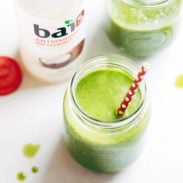 Simple Coconut Green Smoothie in jars with straw.