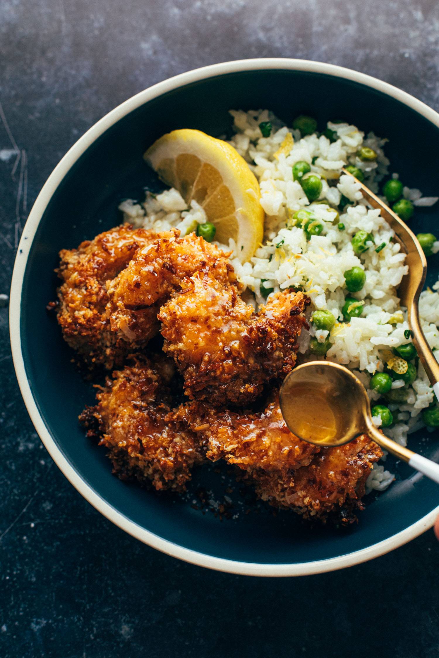Coconut shrimp in a bowl with rice and peas