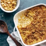 Baked Mac and Cheese in a pan with serving in a bowl.