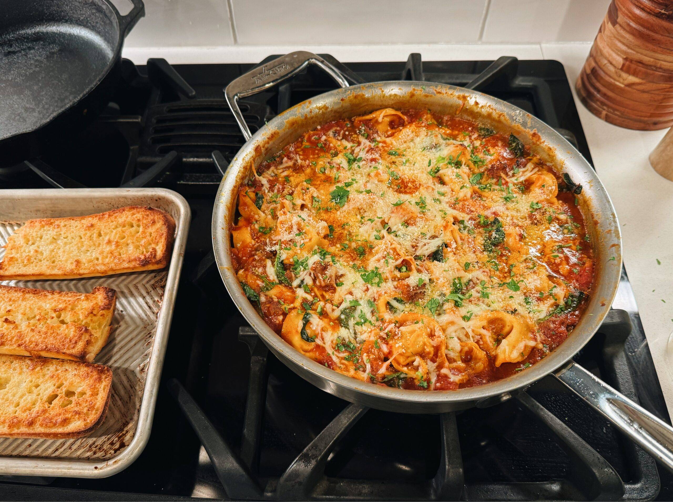 Serving baked tortellini with garlic bread