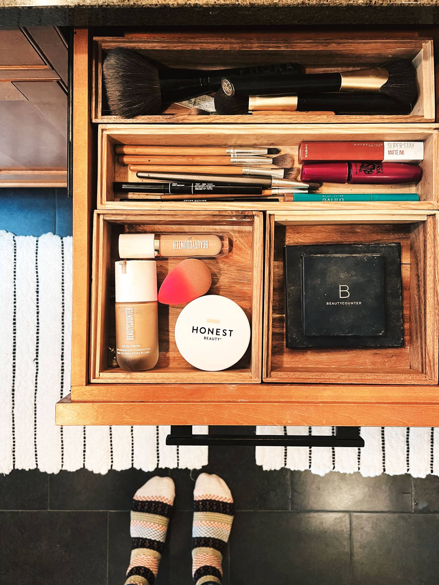 Open makeup drawer with makeup and skincare products