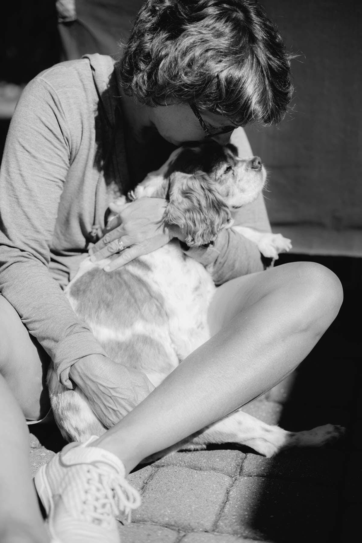 Woman kissing a dog.