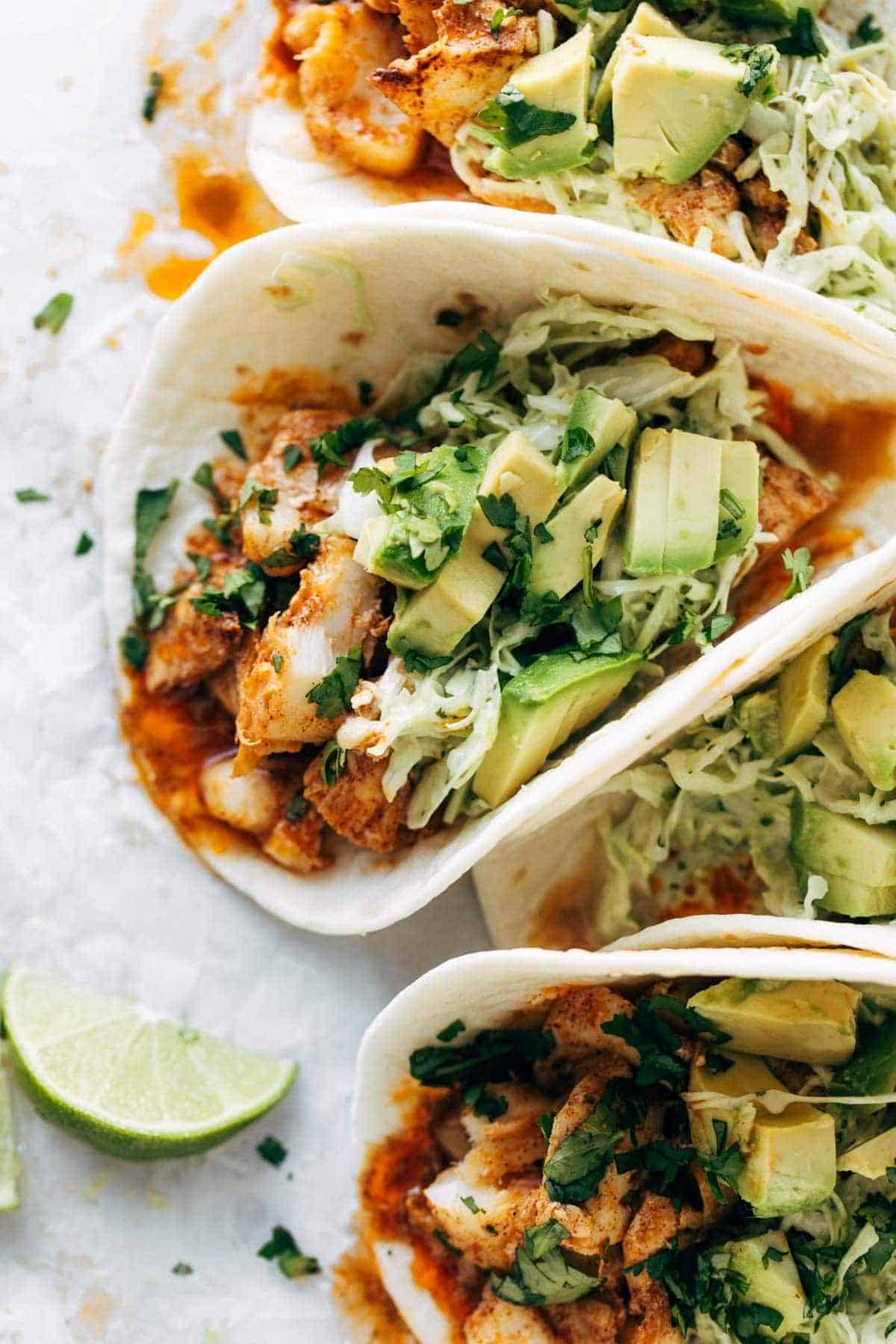 Fish tacos in flour tortillas with slaw.