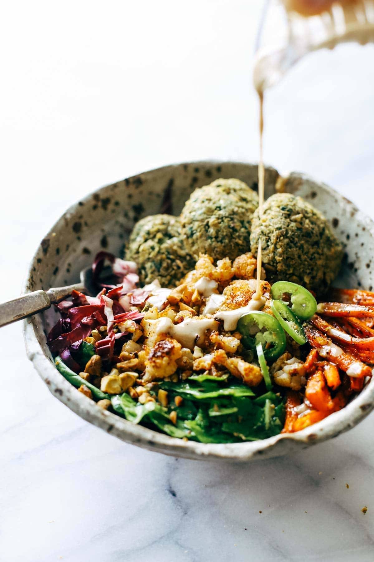 Keep your glow all winter! Easy homemade falafel, roasted veggies, and flavorful sauce all in one big bliss bowl! vegetarian / vegan / gluten free recipe. | pinchofyum.com