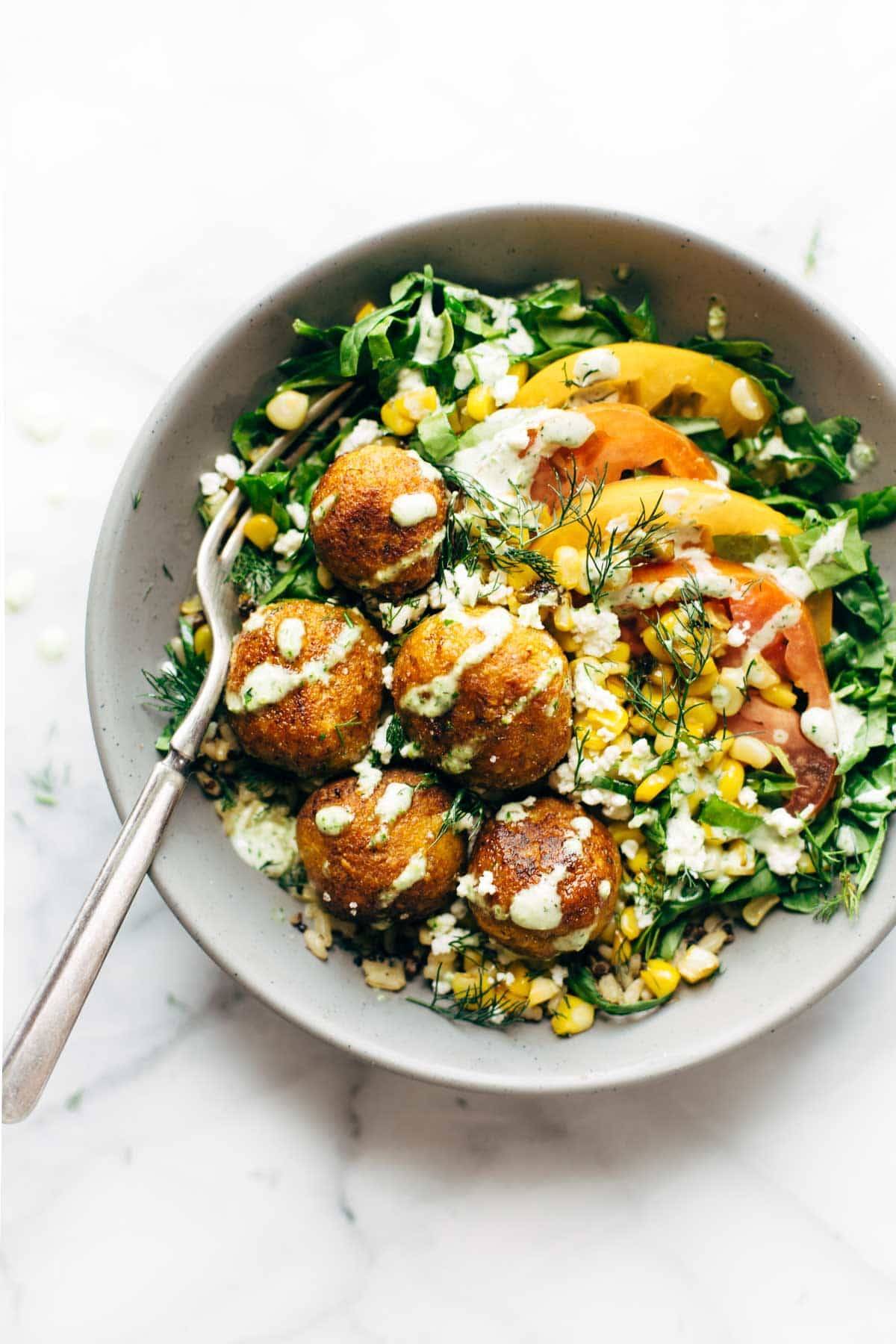 Summer Bliss Bowls with Sweet Potato Falafel and Jalapeño Ranch with a fork.