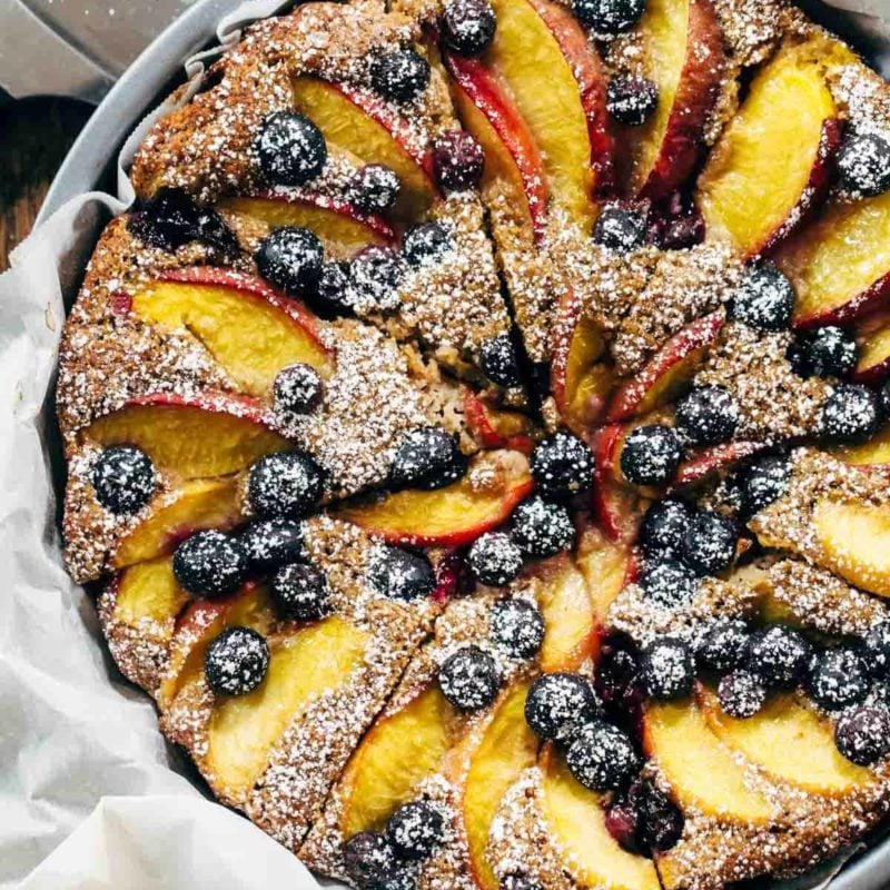 A dessert baked with fruit and powdered sugar on top.