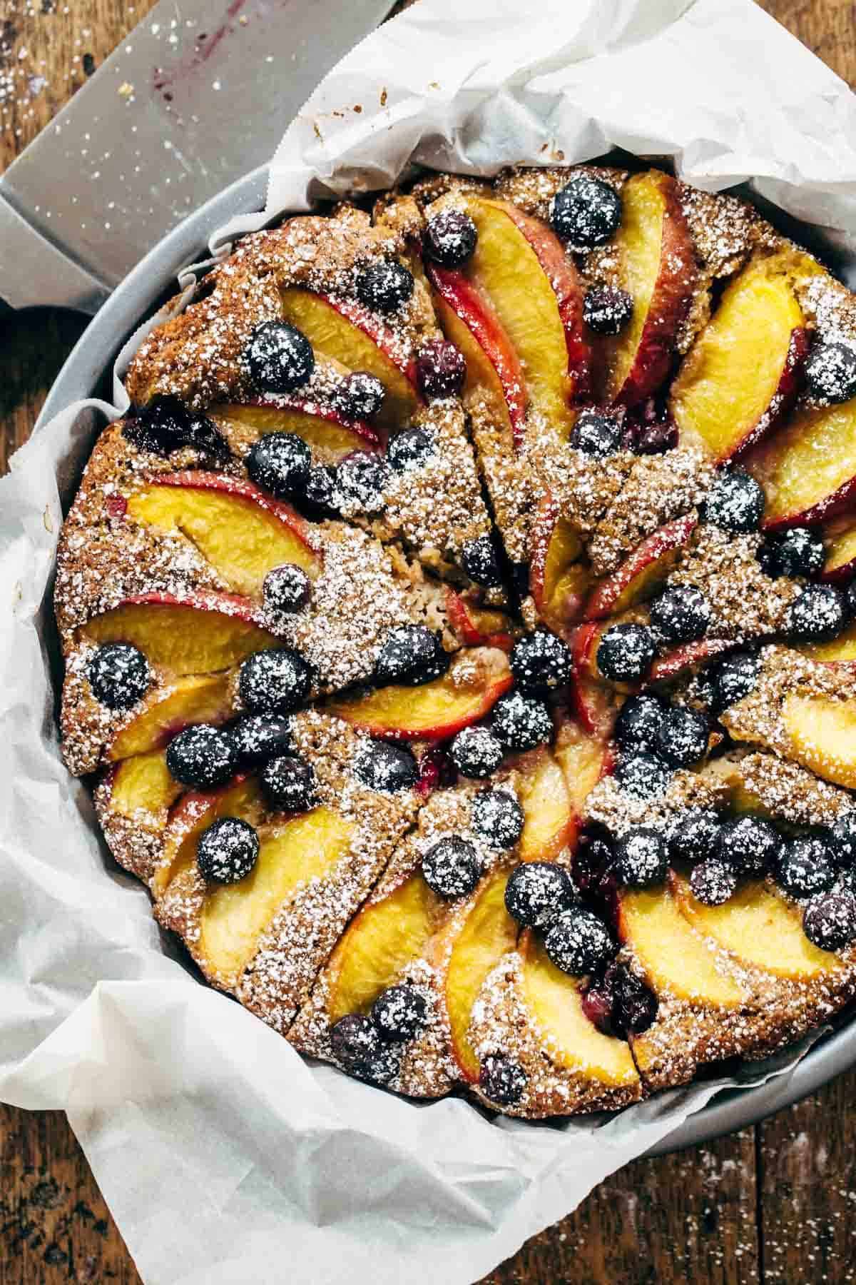 Blueberry Peach Cake recipe uses simple ingredients, whole wheat, no refined sugar, and has a STUNNING presentation. YUM! | pinchofyum.com