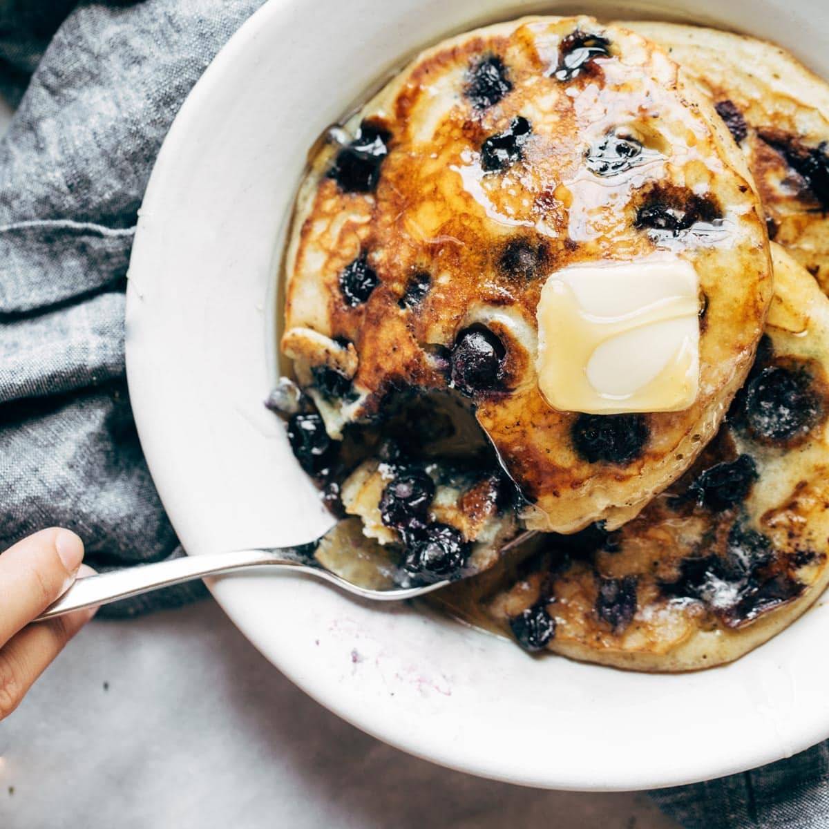 Blueberry pancakes with syrup and butter.