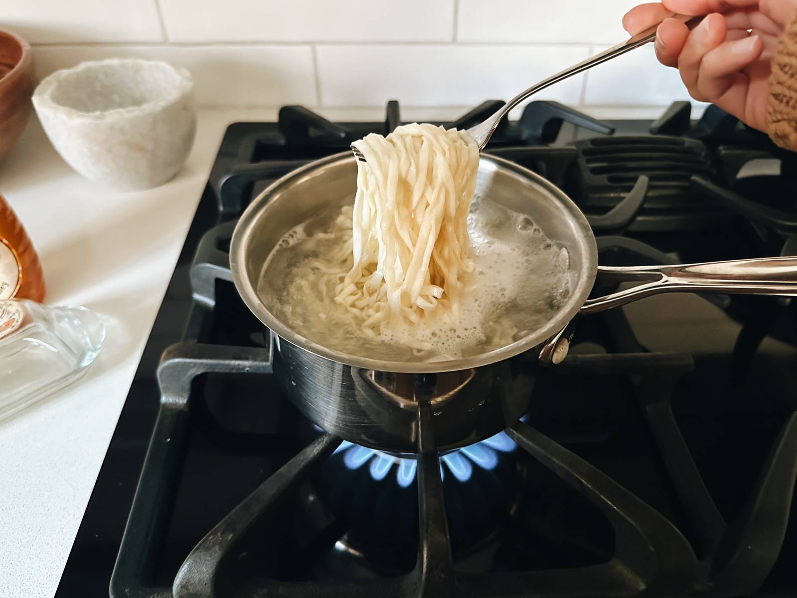 Cooked noodles in a pot of water.