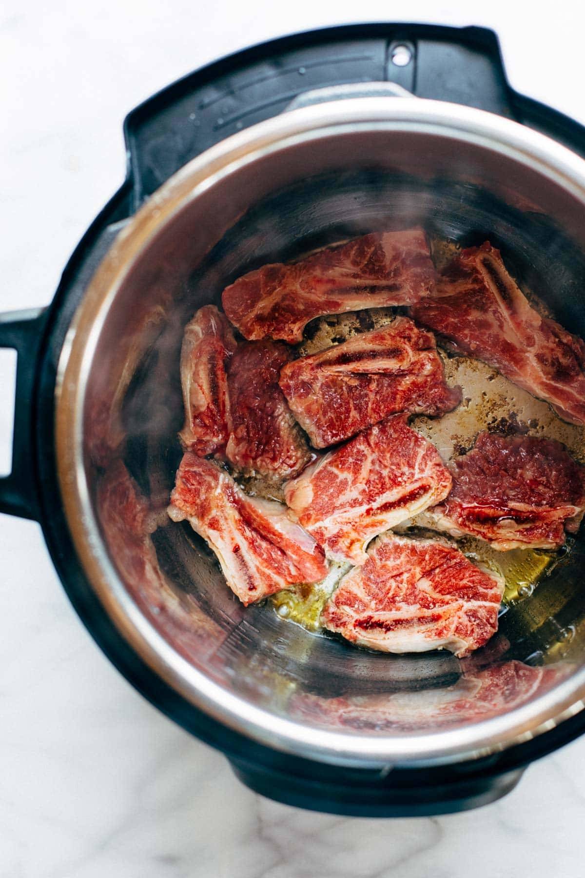 Short ribs browned in an Instant Pot.