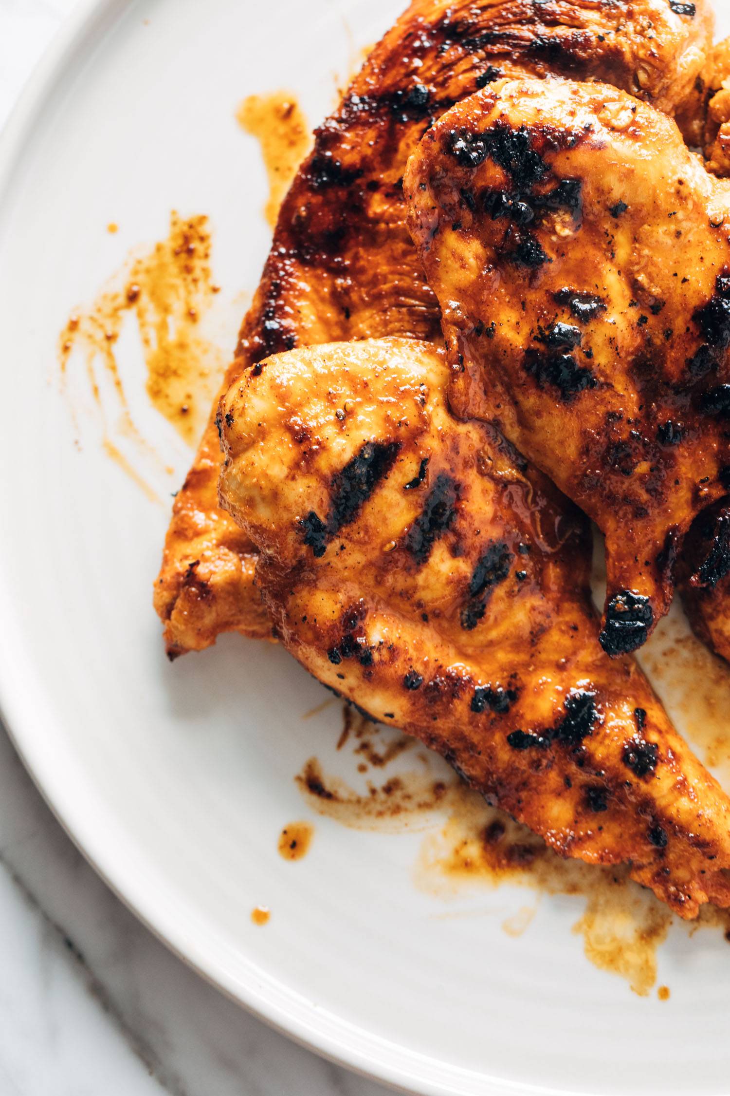 Buffalo chicken breasts on a plate.