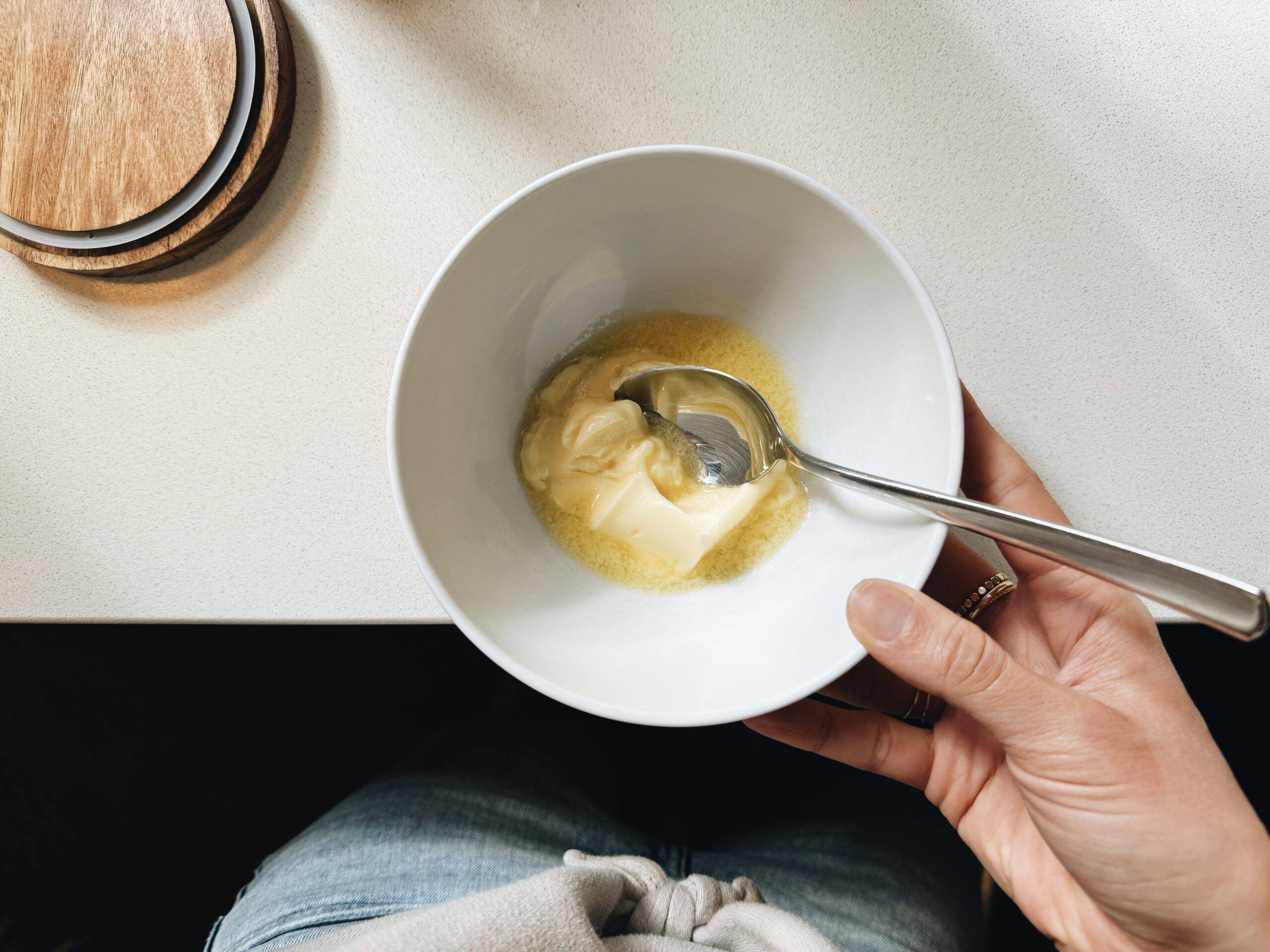 Melted butter in a bowl with a spoon.