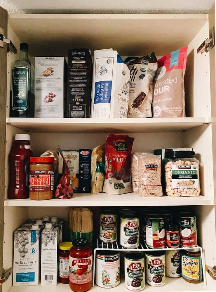Grocery items arranged in the cupboard.