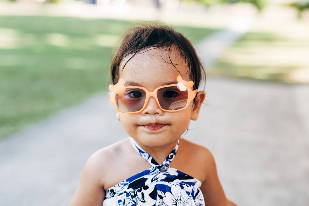 Little girl wearing sunglasses.