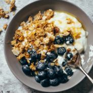 Cabin Granola in a bowl with yogurt and berries.