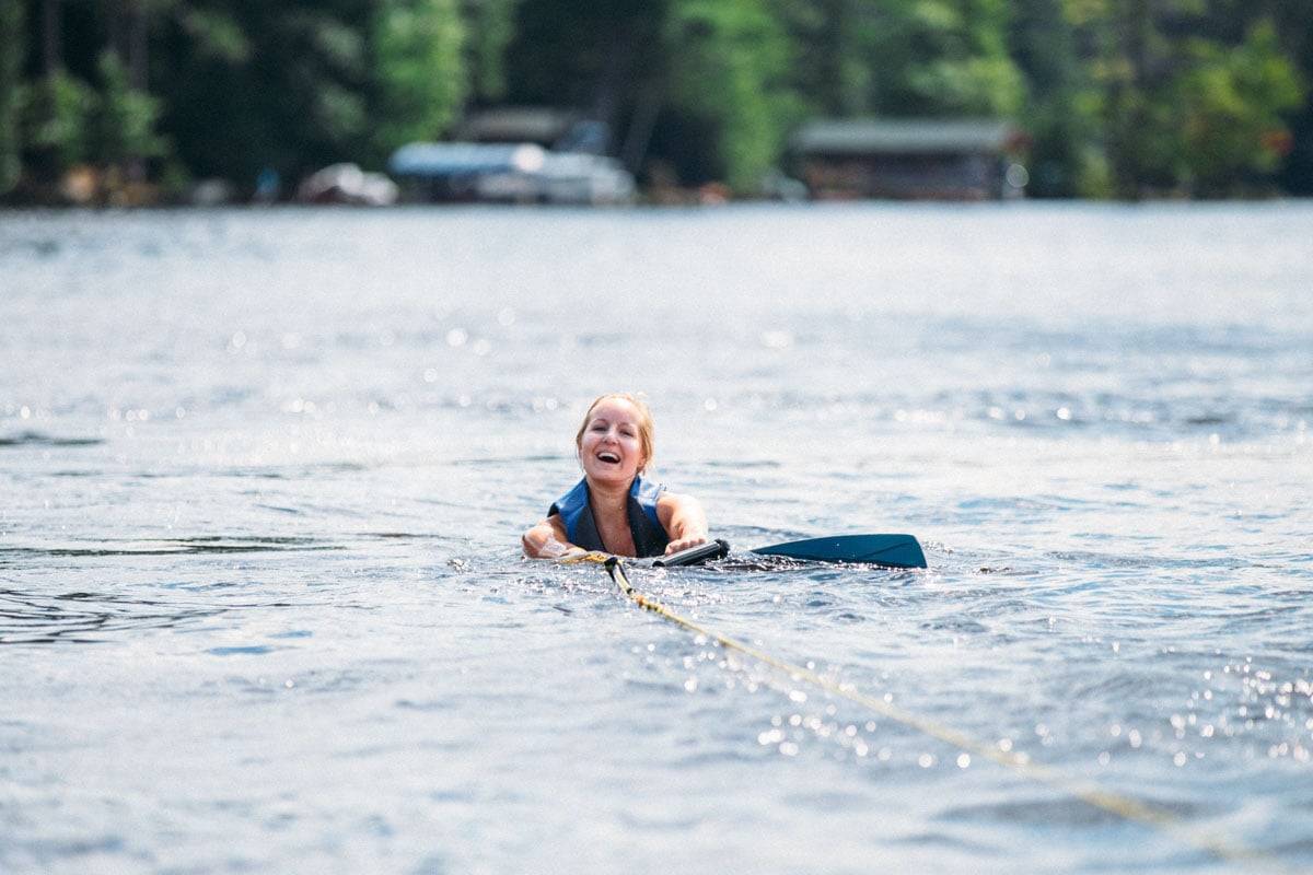 Woman wake boarding on a lake.