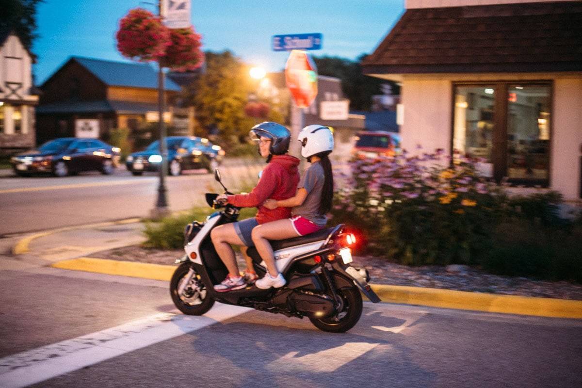 Two people on a moped.