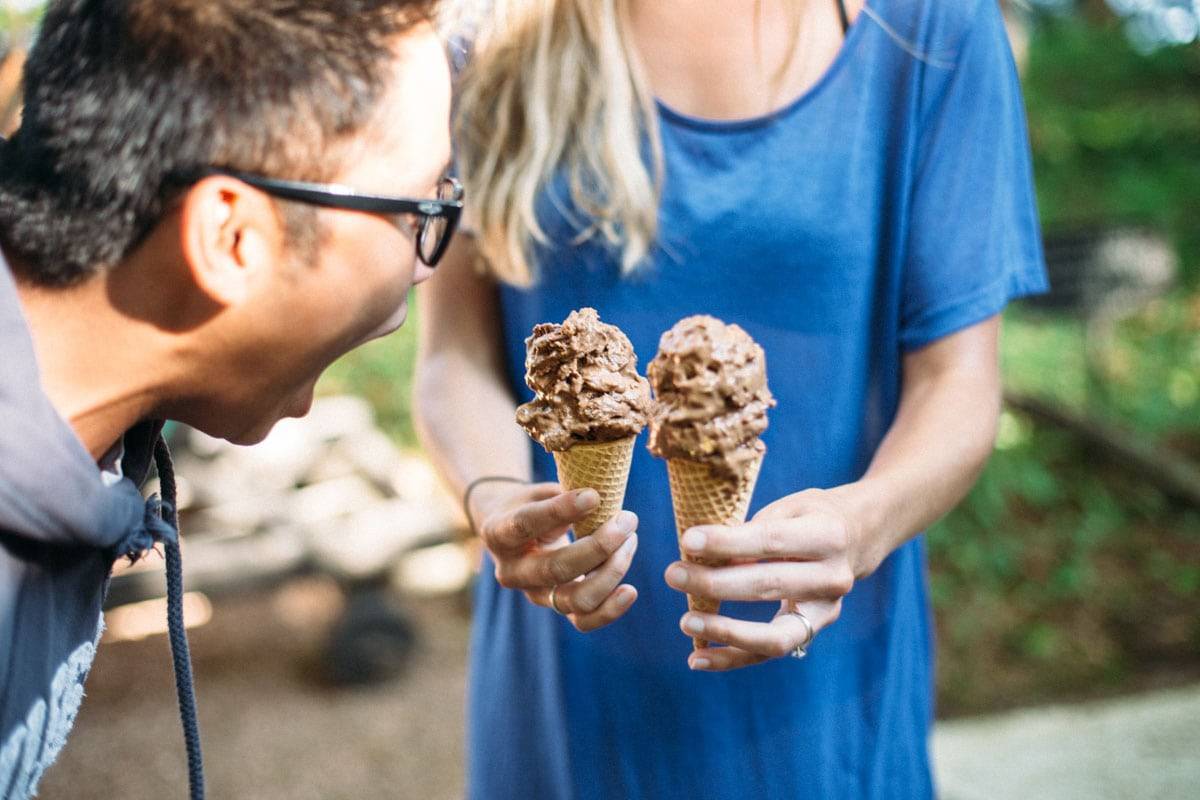 Man pretending to eat two ice cream cones.
