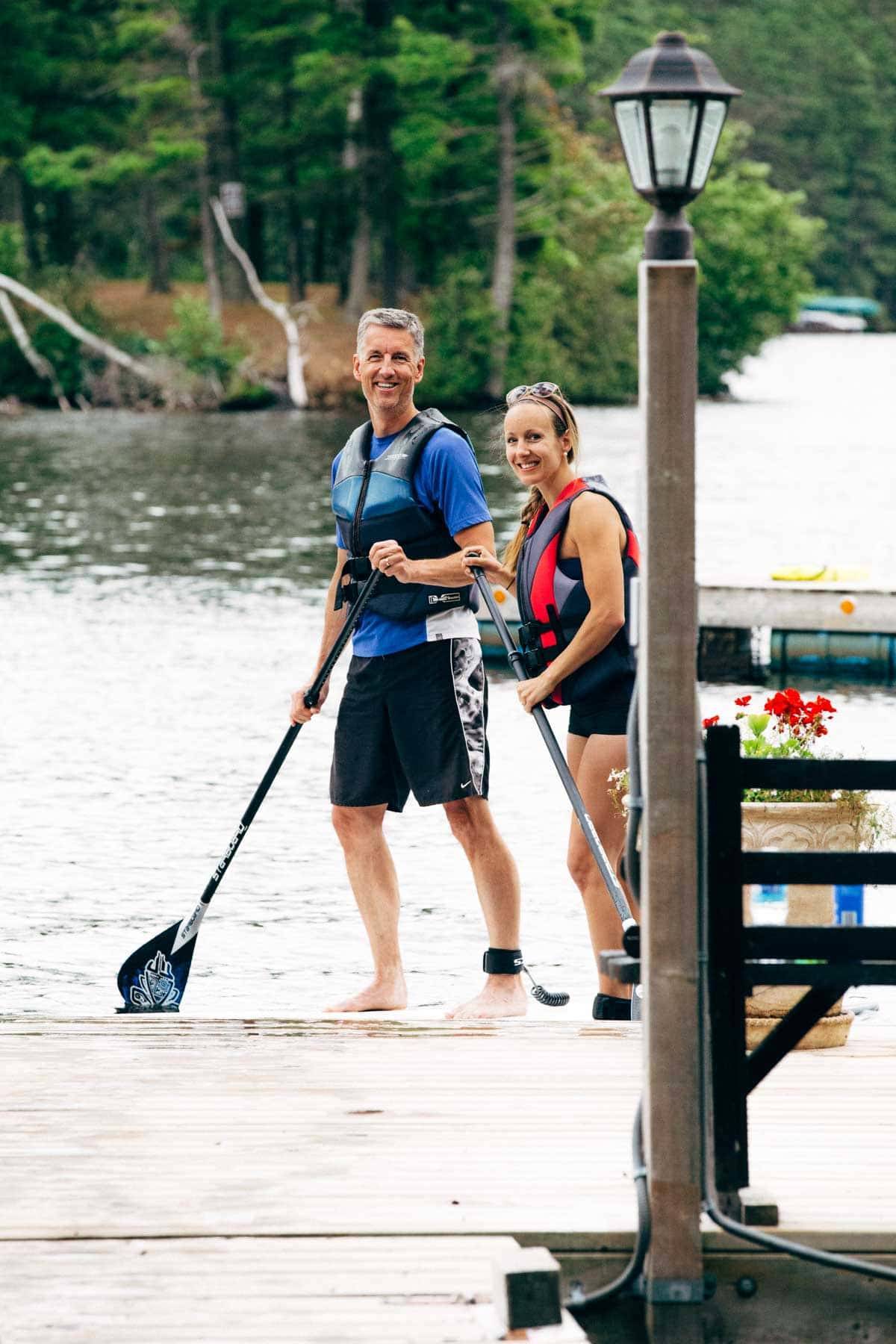 Man and woman paddle boarding.