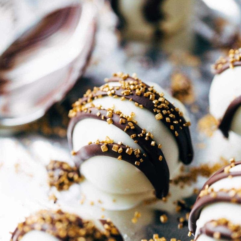 Desserts of white balls with chocolate stripes.