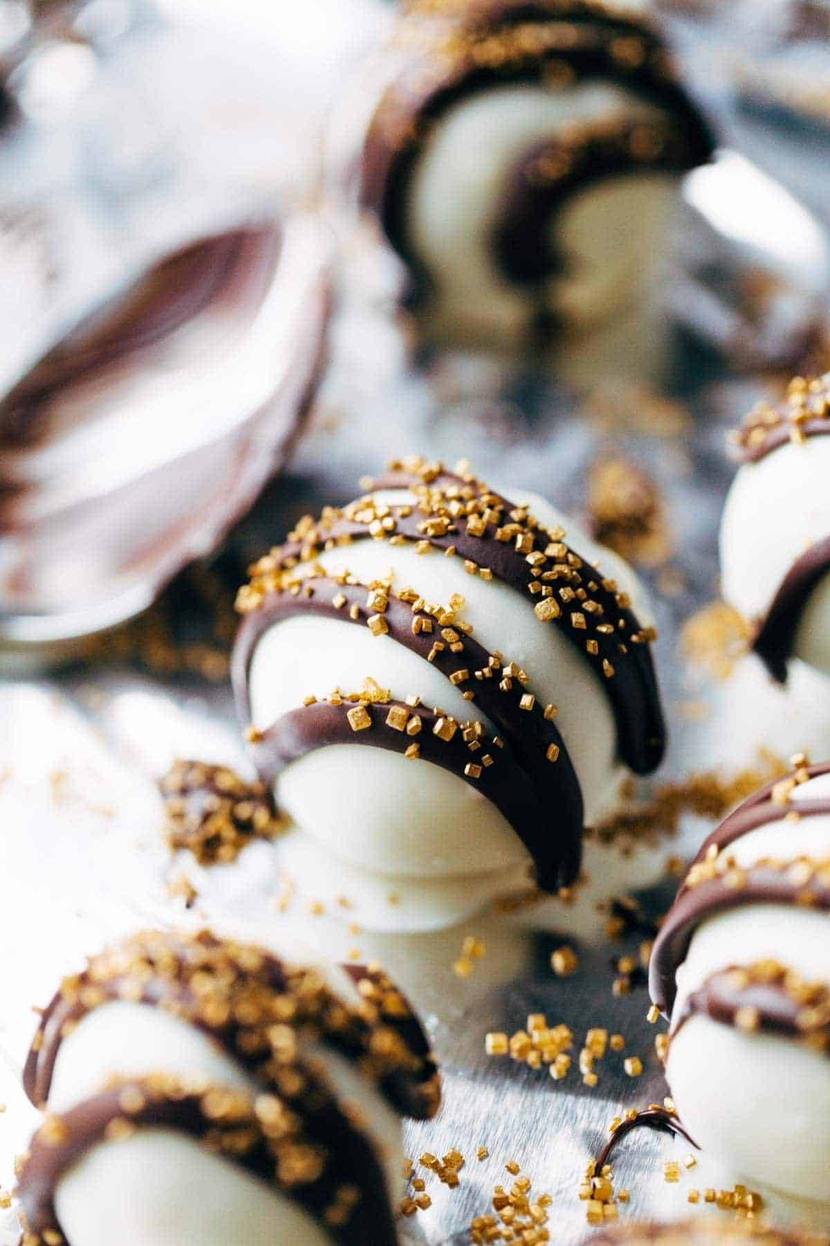 Desserts of white balls with chocolate stripes.