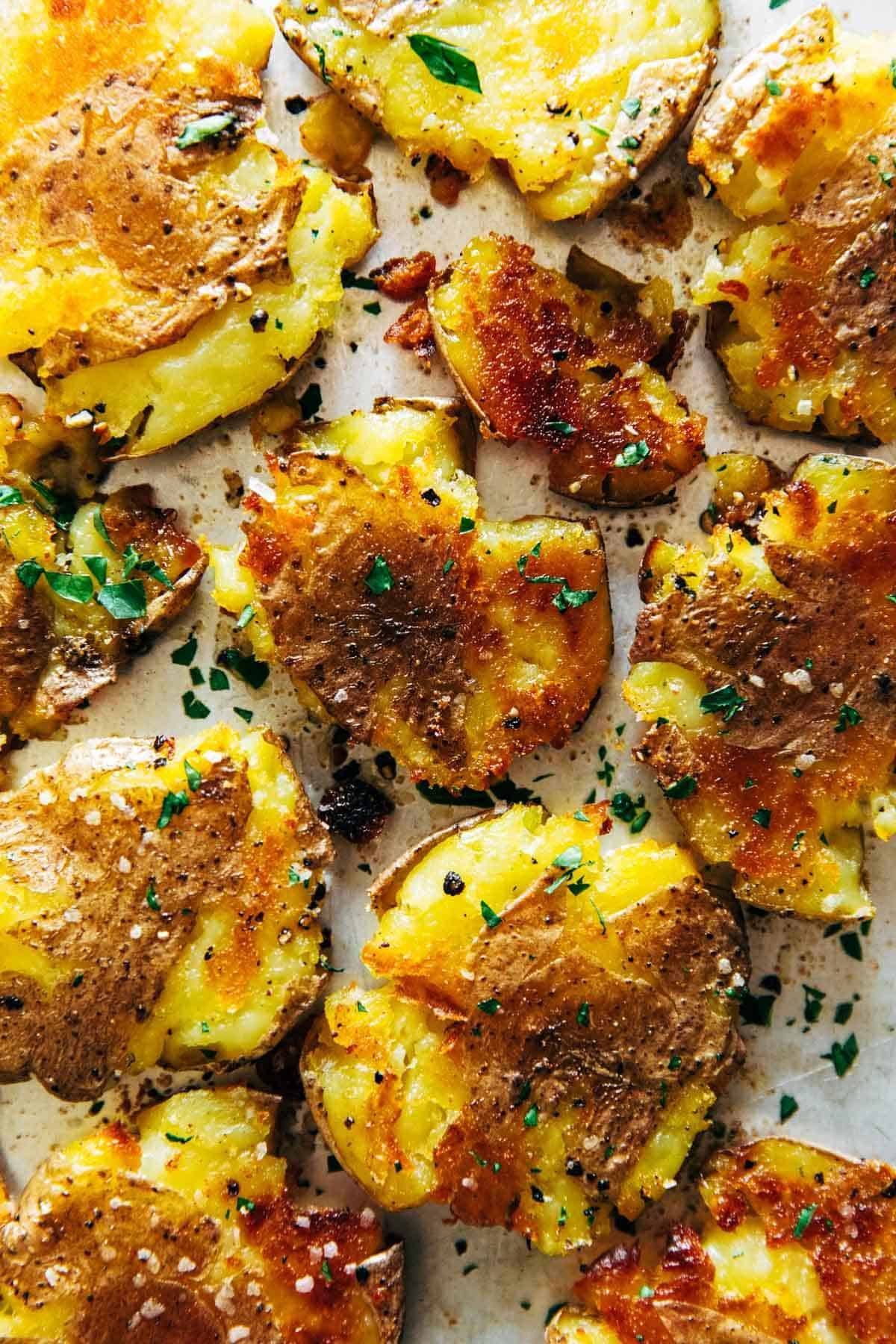 Close-up of smashed potatoes on a pan.