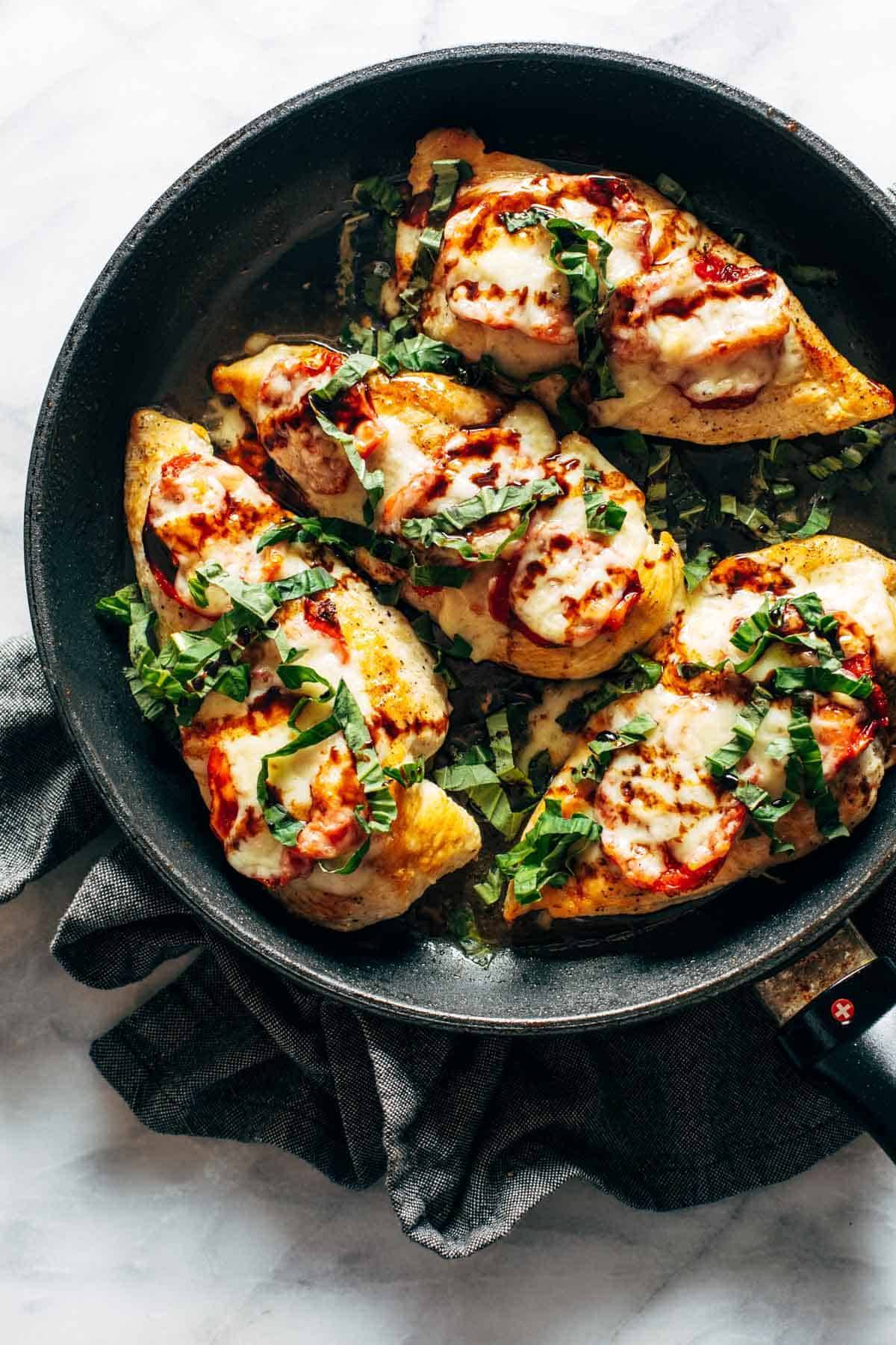 Caprese chicken in a pan.