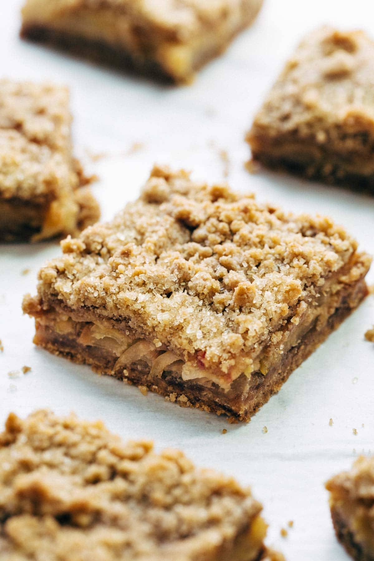 These layered bars are so simple! Loaded with homemade caramel and apples. Caramely apple layer tucked in by a brown sugar-y crust on both sides. | pinchofyum.com