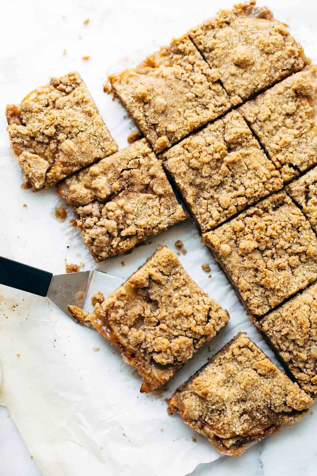 These layered bars are so simple! Loaded with homemade caramel and apples. Caramely apple layer tucked in by a brown sugar-y crust on both sides. | pinchofyum.com