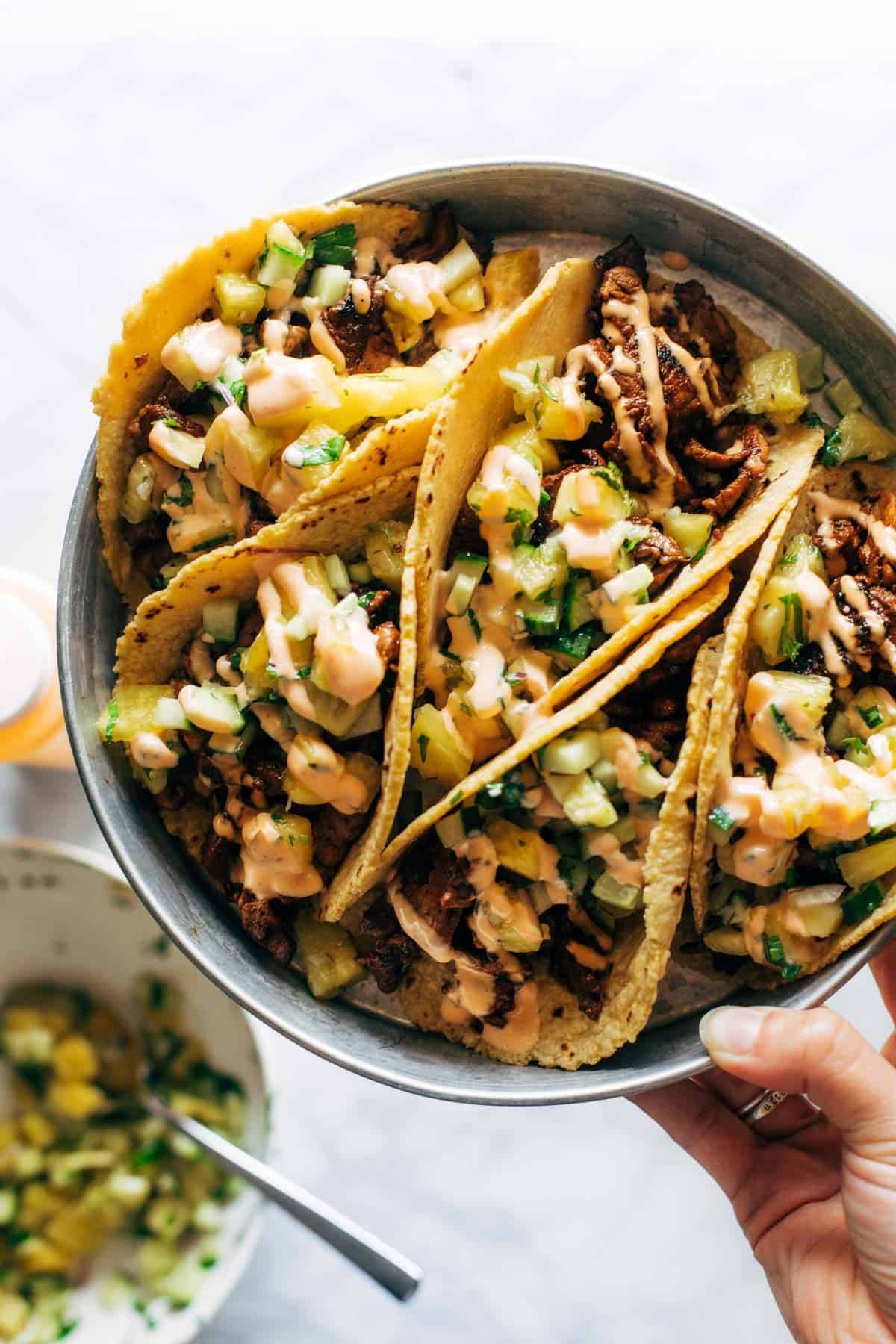 Pork tacos in a dish with a pineapple cucumber salsa