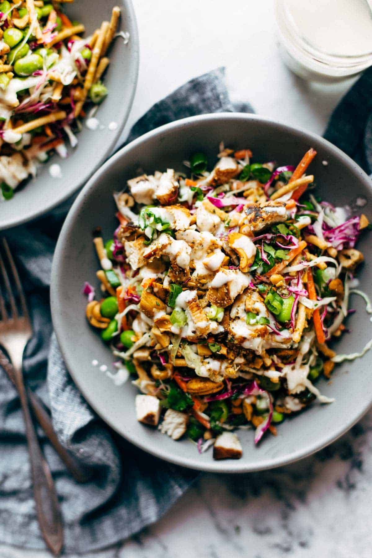 Cashew Crunch Salad in a bowl with dressing.