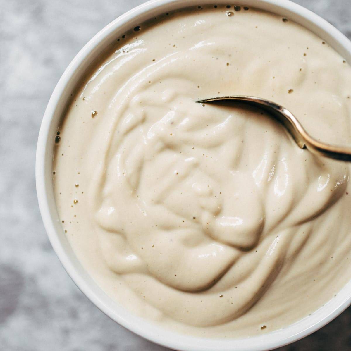 Cashew Sauce in a bowl with a spoon.