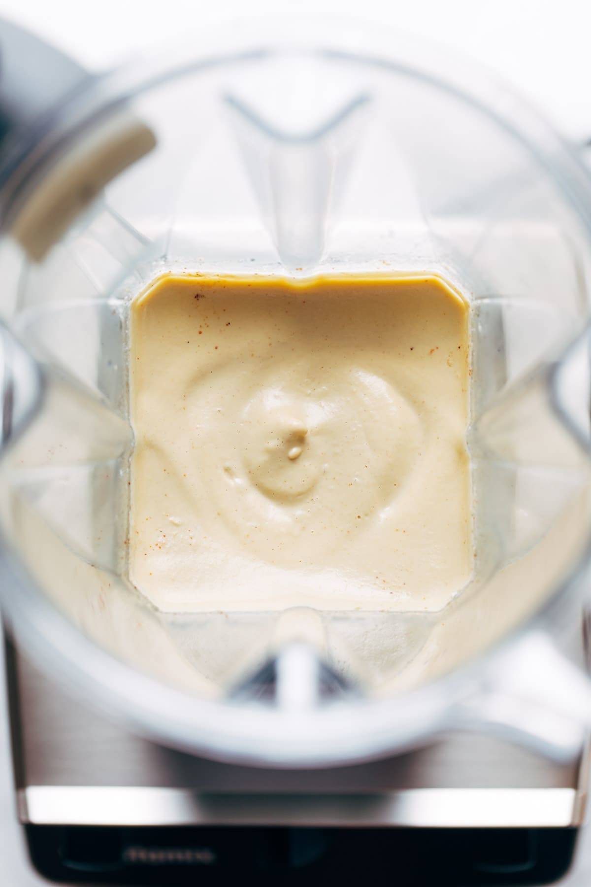 Vegan queso blended in a blender.