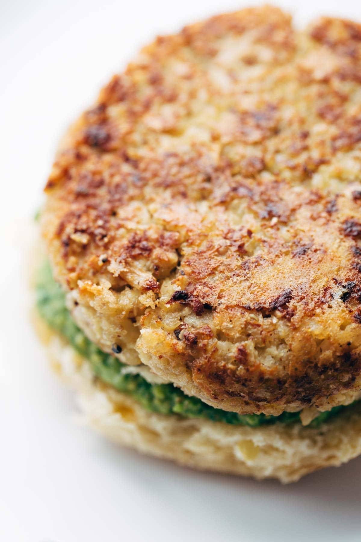 Recipe for Spicy Cauliflower Burgers with avocado sauce, cilantro lime slaw, and chipotle mayo! Meatless, filling, and delicious! | pinchofyum.com