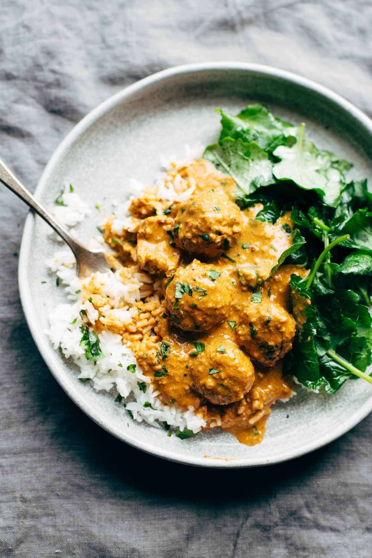 Plate of rice with meatless meatballs with a fork.