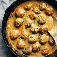 Vegetarian Meatballs in a pan with a wooden spoon.