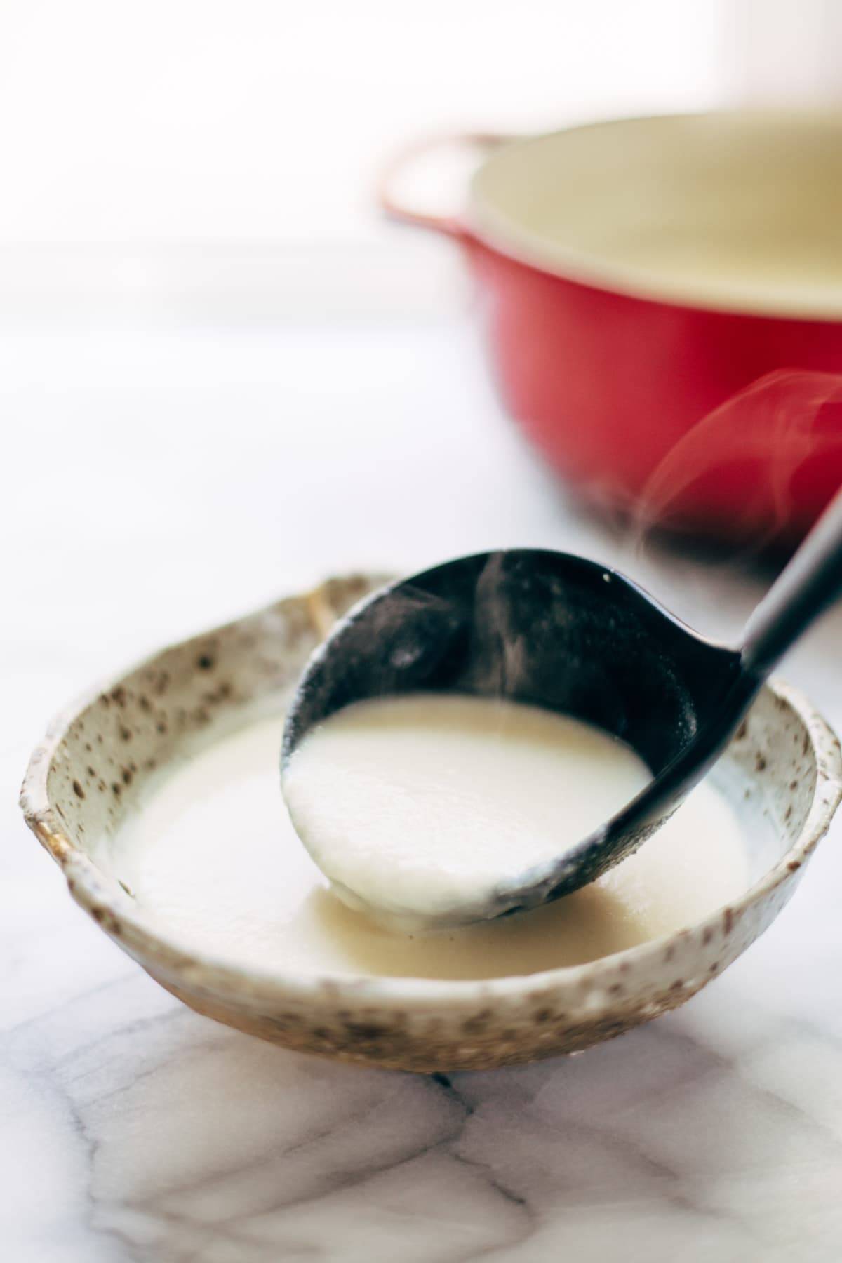 This 5 Ingredient Cheesy Cauliflower Soup is ultra creamy - and all you need is an onion, cauliflower, butter, broth, and cheese! SO EASY. | pinchofyum.com