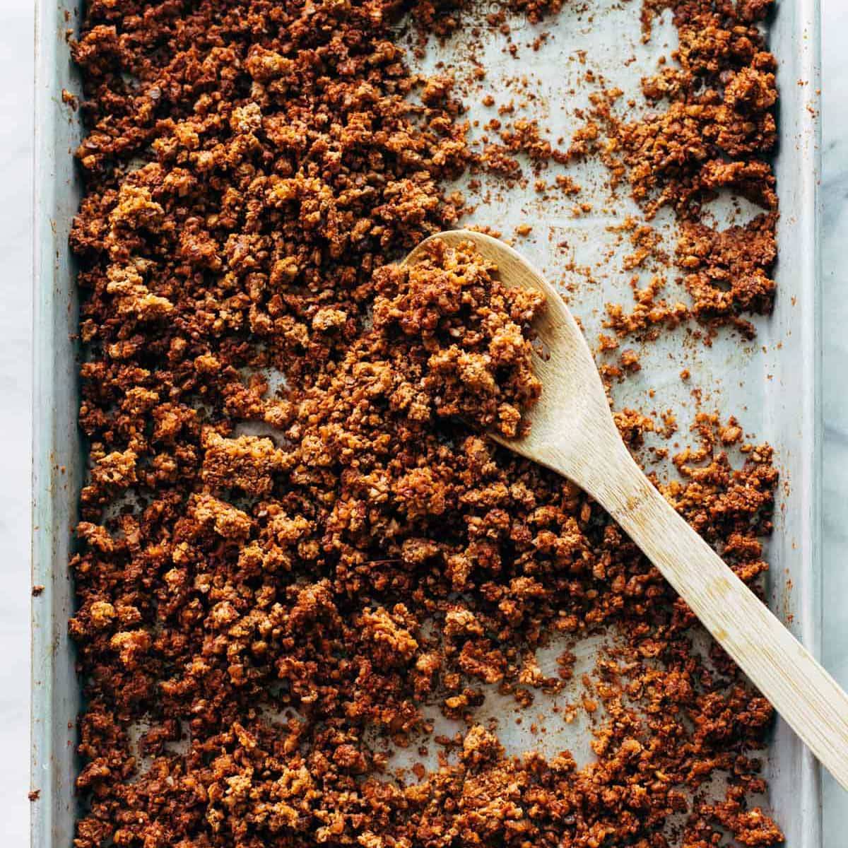 Cauliflower Walnut Vegetarian Taco Meat on a sheet pan with a wooden spoon.