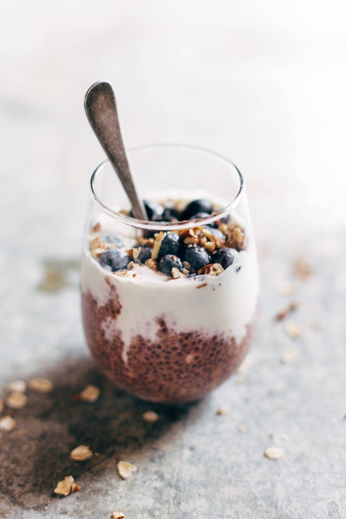 Berry Chia Overnight Oats in a glass with a spoon.