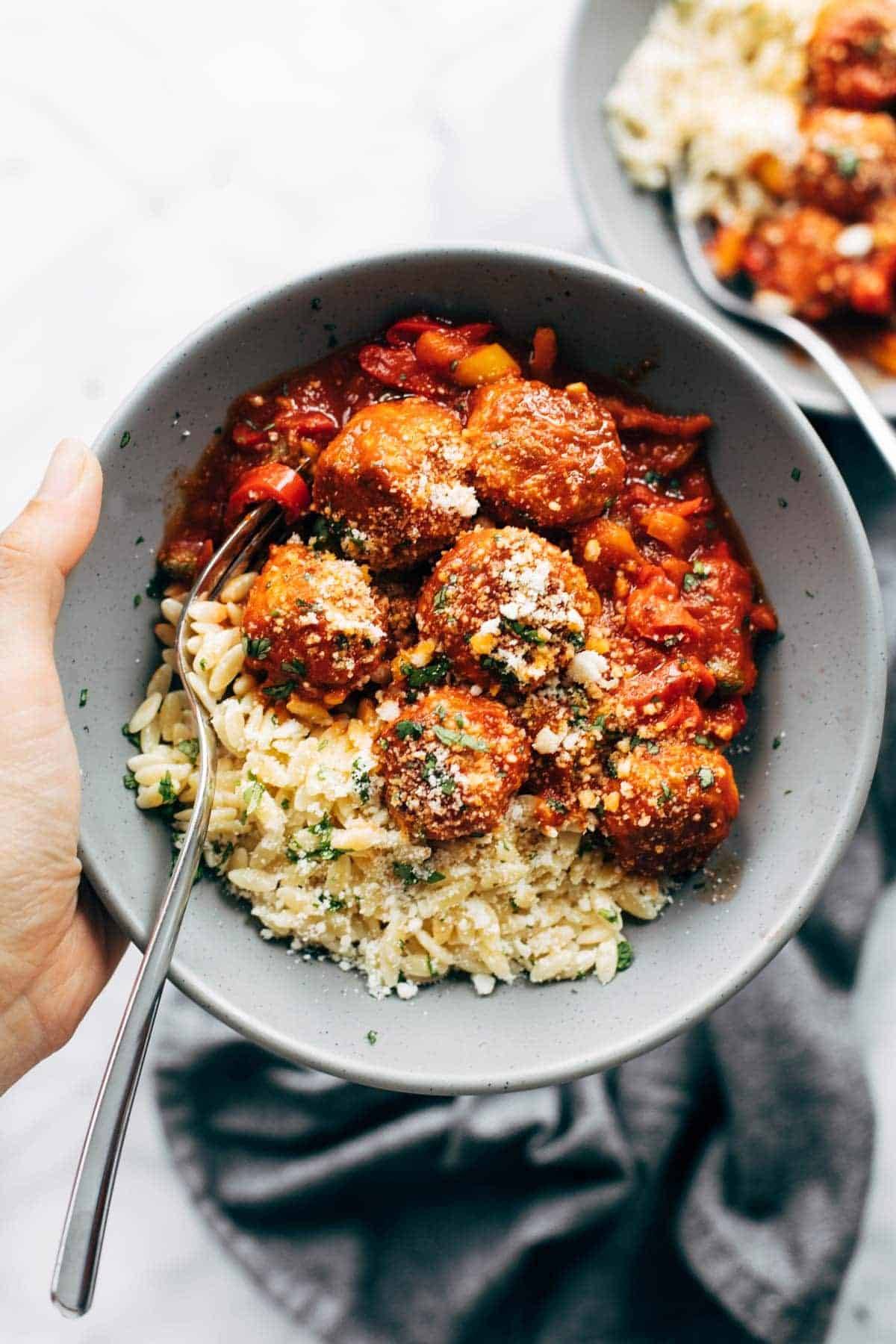 Chicken meatballs with peppers and orzo in a bowl.