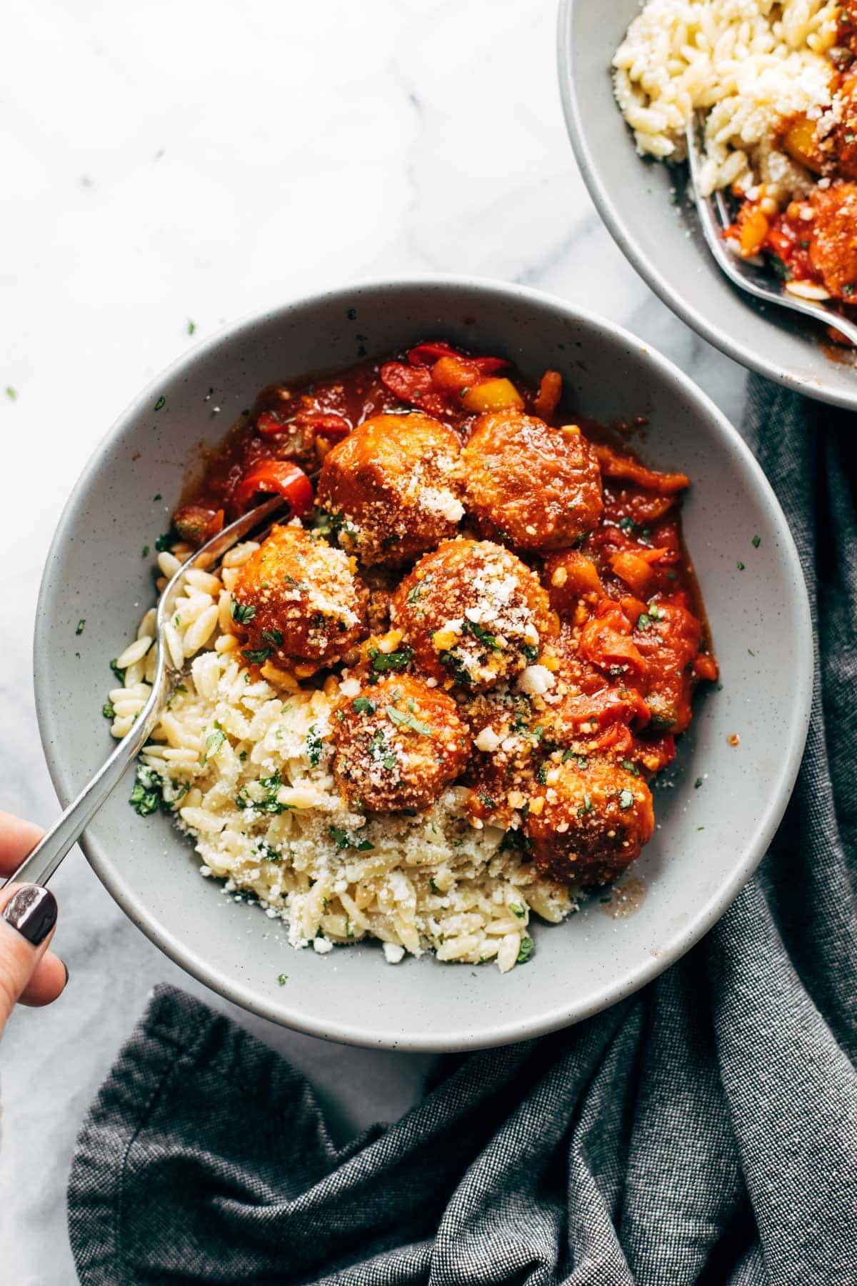 Chicken meatballs with peppers and orzo in a bowl.