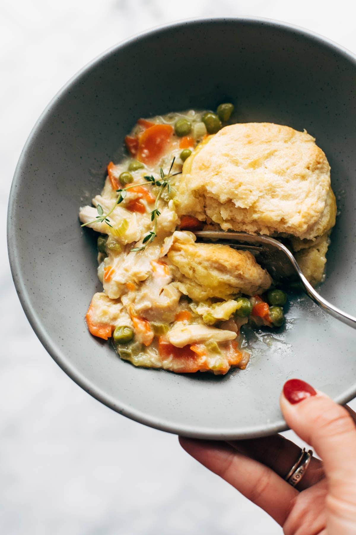 Bowl of chicken pot pie with a biscuit.