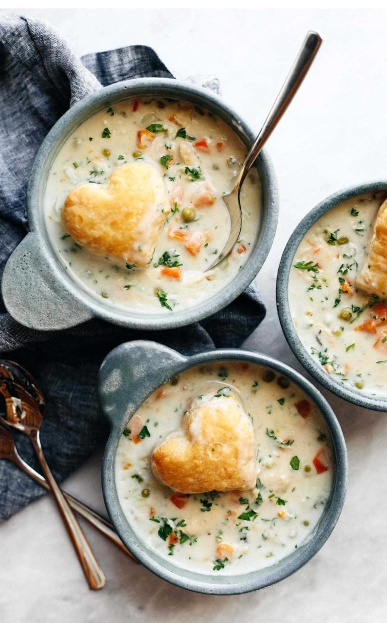 Chicken pot pie soup in bowls with puff pastry hearts on top.