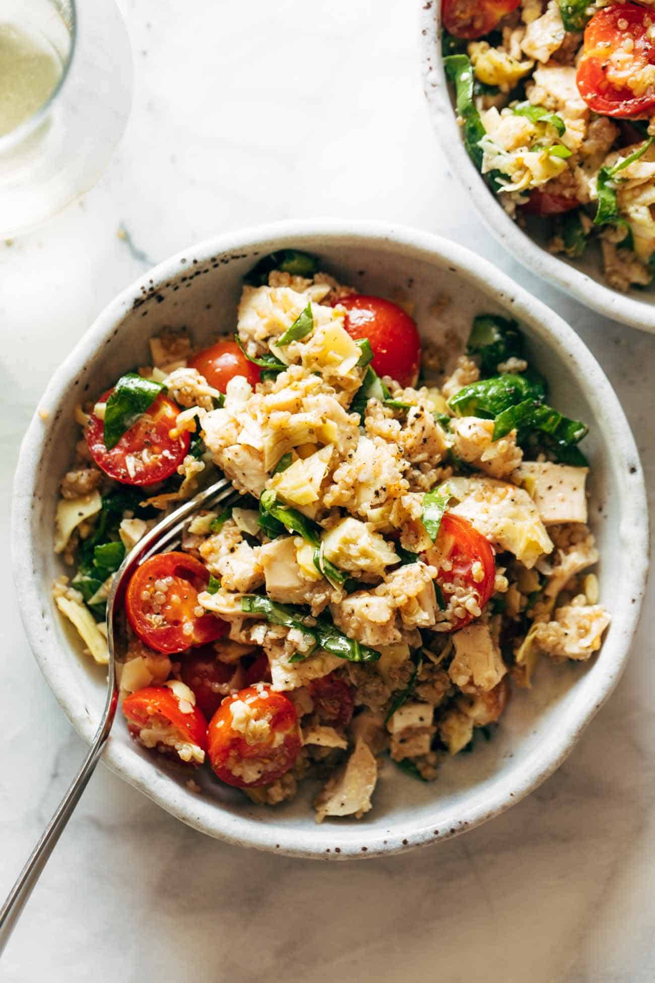 Chicken quinoa salad in a bowl with a fork