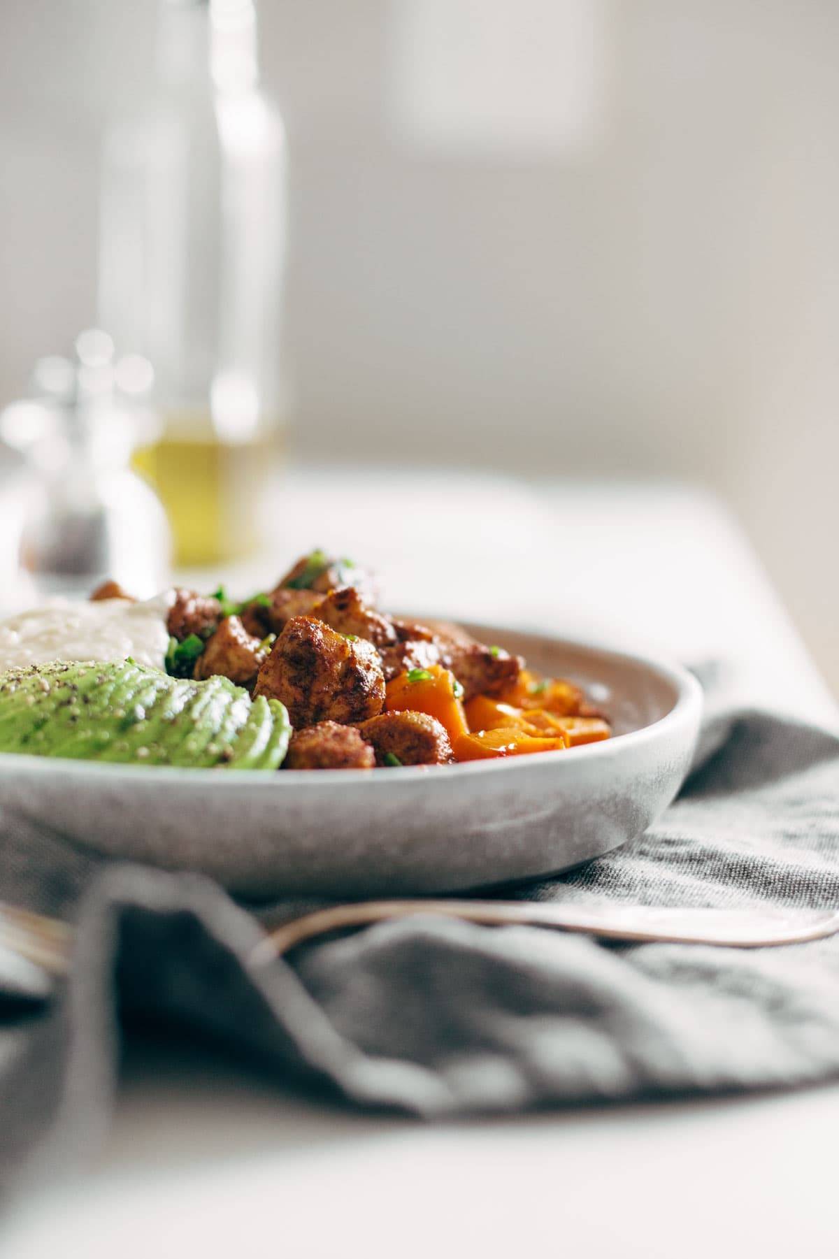 plate of chicken and sweet potatoes with avocado