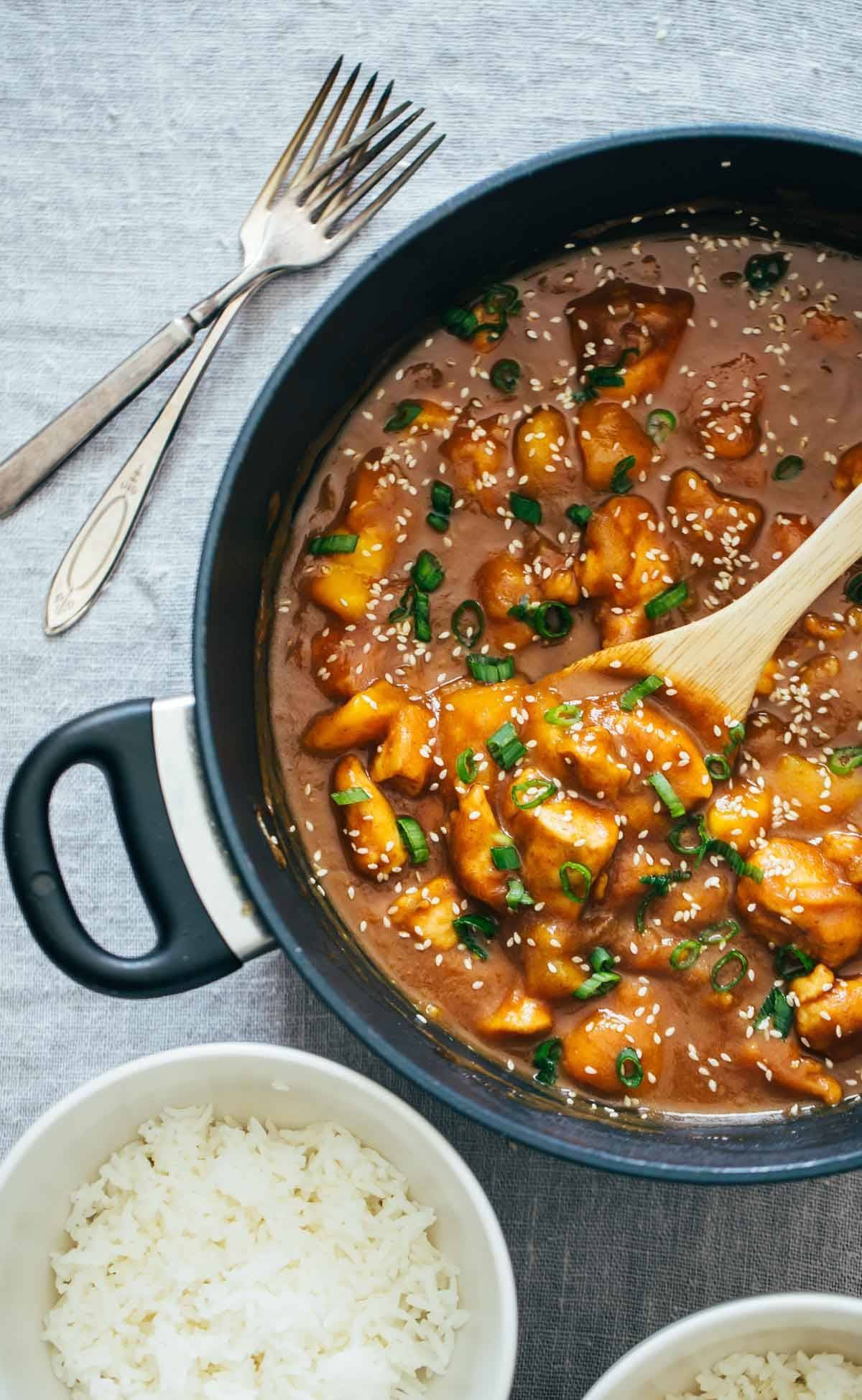 Sesame Mango Chicken Teriyaki in a pan with forks.